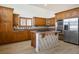 Well-appointed kitchen with stainless steel appliances, a center island and warm wood cabinets at 2204 Ambermill Ct, Henderson, NV 89052