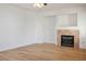 Bright living room featuring a cozy fireplace and wood-look floors at 2204 Ambermill Ct, Henderson, NV 89052