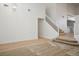 Bright living room with a vaulted ceiling, carpet and wood flooring, and staircase at 2204 Ambermill Ct, Henderson, NV 89052