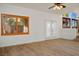 Sun-filled living room with wood-look floors, large windows, and French doors at 2204 Ambermill Ct, Henderson, NV 89052