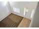 A bright and airy living room shows neutral carpet, a stylish front door, and a large window at 2204 Ambermill Ct, Henderson, NV 89052