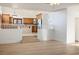 Bright living room with hardwood floors, white walls, and views to the kitchen at 2204 Ambermill Ct, Henderson, NV 89052