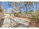 View of backyard showing large stone patio with leafy trees creating a park-like setting at 2340 Hunt Club St, Las Vegas, NV 89128