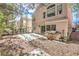 Large stone patio in backyard with view of the home's rear exterior and mature trees at 2340 Hunt Club St, Las Vegas, NV 89128