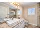 Bright bathroom featuring a modern sink, neutral countertops, and tiled walk-in shower at 2340 Hunt Club St, Las Vegas, NV 89128
