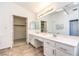 Bright bathroom with double vanity, large mirror, and access to a walk-in closet at 2340 Hunt Club St, Las Vegas, NV 89128