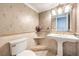 Bathroom featuring a stylish pedestal sink, decorative wallpaper, and modern fixtures at 2340 Hunt Club St, Las Vegas, NV 89128