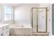 Bathroom featuring a soaking tub, tiled shower, and white cabinetry at 2340 Hunt Club St, Las Vegas, NV 89128