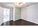 The bedroom features hardwood floors, and an ample closet with stylish doors at 2340 Hunt Club St, Las Vegas, NV 89128