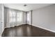 Bedroom featuring hardwood floors and large windows with sheer white curtains at 2340 Hunt Club St, Las Vegas, NV 89128