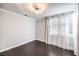 This bedroom has hardwood floors, a modern light fixture, and bright natural light at 2340 Hunt Club St, Las Vegas, NV 89128