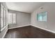 Bedroom with hardwood floors, shuttered windows, and a small decorative window at 2340 Hunt Club St, Las Vegas, NV 89128