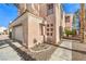 Two-story home featuring mature landscaping, a two-car garage, and gated entry at 2340 Hunt Club St, Las Vegas, NV 89128