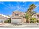 Exterior of a two-story home featuring tile roof, two-car garage, and palm trees at 2340 Hunt Club St, Las Vegas, NV 89128