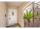 Front door featuring decorative security gate, stucco walls, and tile floors at 2340 Hunt Club St, Las Vegas, NV 89128