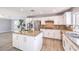 Modern kitchen features an island, stainless steel appliances, granite countertops, and white cabinets at 2340 Hunt Club St, Las Vegas, NV 89128