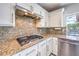 Close-up of kitchen showcasing granite countertops, stainless steel appliances, and white cabinets at 2340 Hunt Club St, Las Vegas, NV 89128