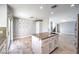 Open layout with kitchen island featuring granite countertops, white cabinetry, and modern chandelier lighting at 2340 Hunt Club St, Las Vegas, NV 89128