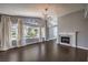 Bright living room features a fireplace, chandelier, and large windows with elegant curtains at 2340 Hunt Club St, Las Vegas, NV 89128