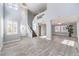 Bright, open-concept living room with soaring ceilings, wood-look flooring, and elegant chandelier lighting at 2340 Hunt Club St, Las Vegas, NV 89128