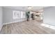 Open-concept living area features wood-look floors, modern lighting, and seamless flow to the kitchen at 2340 Hunt Club St, Las Vegas, NV 89128