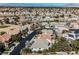 Neighborhood aerial view near a golf course with mountain backdrop and lush landscaping at 2493 Ram Crossing Way, Henderson, NV 89074