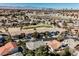 Panoramic aerial shot showcasing the lush neighborhood and the golf course nearby at 2493 Ram Crossing Way, Henderson, NV 89074