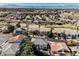 Extensive neighborhood aerial view with golf course, mature trees, and mountain backdrop at 2493 Ram Crossing Way, Henderson, NV 89074