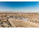 A desert cityscape under a bright sky, with houses and commercial areas stretching towards the distant mountains at 2493 Ram Crossing Way, Henderson, NV 89074