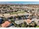 Scenic aerial view of the property, showing neighborhood, golf course, and mountain views at 2493 Ram Crossing Way, Henderson, NV 89074
