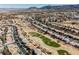A landscape view captures an entire neighborhood and golf course under clear, bright blue skies at 2493 Ram Crossing Way, Henderson, NV 89074