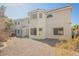 Exterior rear view of the property showcasing the neutral stucco, gravel and some greenery at 2493 Ram Crossing Way, Henderson, NV 89074