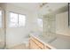 Traditional bathroom with a white tile countertop, bright window and a shower at 2493 Ram Crossing Way, Henderson, NV 89074