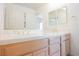 Bathroom with a double sink vanity featuring updated fixtures and a large mirror at 2493 Ram Crossing Way, Henderson, NV 89074