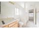 Bathroom featuring a vanity, toilet, bathtub with shower, and a large mirror at 2493 Ram Crossing Way, Henderson, NV 89074