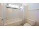 Bathroom with a bathtub and shower featuring white tiling, a blue accent stripe and gold fixtures at 2493 Ram Crossing Way, Henderson, NV 89074