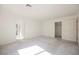 Empty room featuring neutral walls, carpet flooring, and multiple doorways to other rooms at 2493 Ram Crossing Way, Henderson, NV 89074