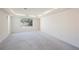 Bedroom with neutral walls, carpet and a large window overlooking the backyard at 2493 Ram Crossing Way, Henderson, NV 89074