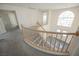 A view of the entryway from the second story with a beautiful staircase at 2493 Ram Crossing Way, Henderson, NV 89074