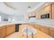 Traditional kitchen featuring wood cabinets, island with sink, and black appliances at 2493 Ram Crossing Way, Henderson, NV 89074