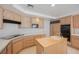 Traditional kitchen with wood cabinets, island with sink, and stainless steel appliances at 2493 Ram Crossing Way, Henderson, NV 89074