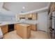 Traditional kitchen featuring wood cabinets, an island with a sink, and appliances at 2493 Ram Crossing Way, Henderson, NV 89074