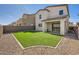 Private backyard with artificial grass lawn and low maintenance desert landscaping at 3004 Moulin Heights St, Las Vegas, NV 89156