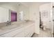 Bright bathroom featuring double sinks, tile floors, and a toilet in separate room at 3004 Moulin Heights St, Las Vegas, NV 89156