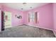 A cute bedroom featuring pink walls, gray carpet, and an attached bathroom at 3004 Moulin Heights St, Las Vegas, NV 89156