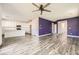 Spacious open-concept living room and kitchen area with modern wood flooring and sleek appliances at 3004 Moulin Heights St, Las Vegas, NV 89156