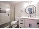 Updated bathroom featuring a shower with glass door, modern vanity and round mirror at 3151 Soaring Gulls Dr # 1079, Las Vegas, NV 89128