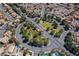 Community aerial view with lush landscaping and pond areas, surrounded by homes with terracotta roofs at 3213 Oyster Bay St, Las Vegas, NV 89117