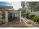 Spacious backyard with covered patio, brick flooring, artificial grass and a mature tree at 3213 Oyster Bay St, Las Vegas, NV 89117