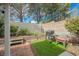 Backyard features brick patio, artificial turf, BBQ grill, and a seating area at 3213 Oyster Bay St, Las Vegas, NV 89117